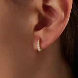 Model wearing 14k gold vermeil U shape hoop earrings that showcase their elegant curvature and radiant sparkle — perfect for both everyday wear and special occasions.
