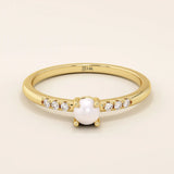 Delicate 14k solid gold promise ring featuring a small lustrous pearl. Minimalist and elegant design perfect for everyday wear.