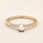 Delicate 14k solid gold promise ring featuring a small lustrous pearl. Minimalist and elegant design perfect for everyday wear.