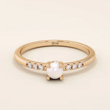 Delicate 14k solid gold promise ring featuring a small lustrous pearl. Minimalist and elegant design perfect for everyday wear.