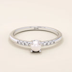 Delicate 14k solid gold promise ring featuring a small lustrous pearl. Minimalist and elegant design perfect for everyday wear.