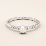 Delicate 14k solid gold promise ring featuring a small lustrous pearl. Minimalist and elegant design perfect for everyday wear.