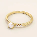 Delicate 14k solid gold promise ring featuring a small lustrous pearl. Minimalist and elegant design perfect for everyday wear.