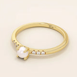 Delicate 14k solid gold promise ring featuring a small lustrous pearl. Minimalist and elegant design perfect for everyday wear.