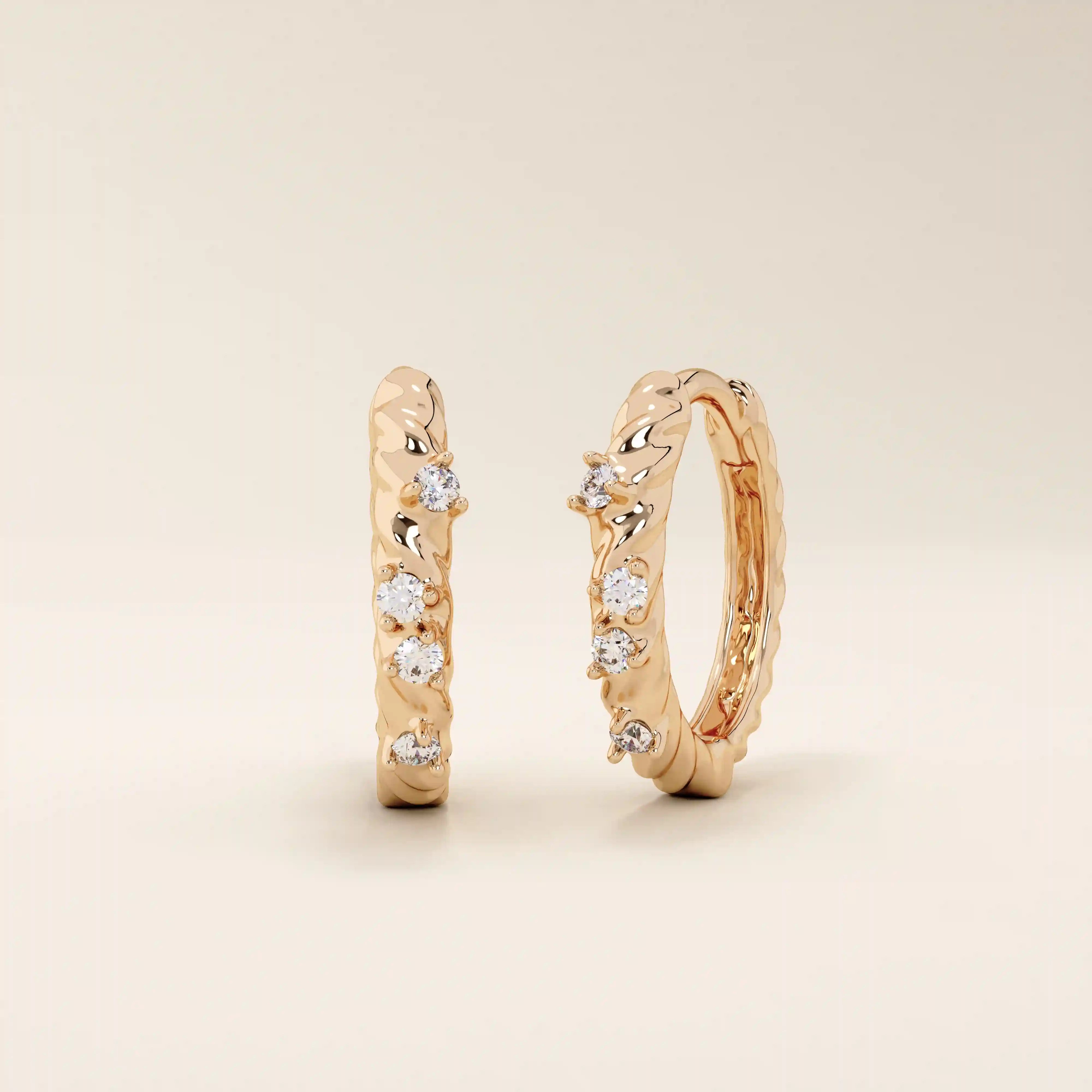 Elegant twist rope hoop earrings in 14k rose gold with moissanite accents.

