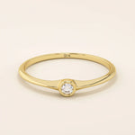 Minimalist 14k solid gold promise ring with a tiny bezel-set moissanite. Sleek and delicate design ideal for everyday wear.