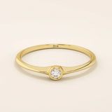 Minimalist 14k solid gold promise ring with a tiny bezel-set moissanite. Sleek and delicate design ideal for everyday wear.