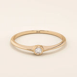 Minimalist 14k solid gold promise ring with a tiny bezel-set moissanite. Sleek and delicate design ideal for everyday wear.