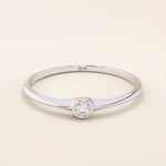Minimalist 14k solid gold promise ring with a tiny bezel-set moissanite. Sleek and delicate design ideal for everyday wear.