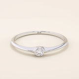 Minimalist 14k solid gold promise ring with a tiny bezel-set moissanite. Sleek and delicate design ideal for everyday wear.