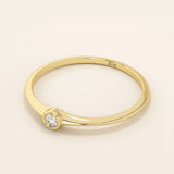 Minimalist 14k solid gold promise ring with a tiny bezel-set moissanite. Sleek and delicate design ideal for everyday wear.