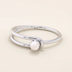 Minimalist 14k solid gold split band promise ring featuring a single lustrous pearl. Elegant design perfect for everyday wear or special occasions.