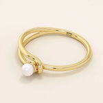 Minimalist 14k solid gold split band promise ring featuring a single lustrous pearl. Elegant design perfect for everyday wear or special occasions.