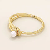 Minimalist 14k solid gold split band promise ring featuring a single lustrous pearl. Elegant design perfect for everyday wear or special occasions.