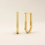 Minimalist U-shape hoop earrings in 14k yellow gold with a sleek modern finish.
