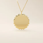 Minimalist sun-shaped necklace in 14k solid gold with a smooth, engravable surface. A timeless everyday piece perfect for personalization and gifting.