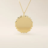 Minimalist sun-shaped necklace in 14k solid gold with a smooth, engravable surface. A timeless everyday piece perfect for personalization and gifting.