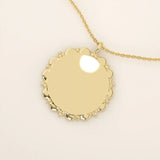 Minimalist sun-shaped necklace in 14k solid gold with a smooth, engravable surface. A timeless everyday piece perfect for personalization and gifting.