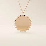 Minimalist sun-shaped necklace in 14k solid gold with a smooth, engravable surface. A timeless everyday piece perfect for personalization and gifting.