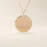 Minimalist sun-shaped necklace in 14k solid gold with a smooth, engravable surface. A timeless everyday piece perfect for personalization and gifting.