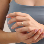 Model wearing a 14k solid gold bezel mixed cut promise ring, showcasing its sparkling moissanite stones and modern, elegant style.