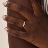 Model wearing a 14k solid gold bezel mixed cut promise ring, showcasing its sparkling moissanite stones and modern, elegant style.