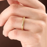 Model wearing a 14k gold vermeil minimalist band ring with ridged design, dainty gold stacking ring for women’s everyday look.

