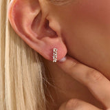 Model wearing baguette cluster stud earrings in 14k gold, showing their sparkling and contemporary clustered silhouette.
