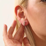 Model wearing baguette cluster stud earrings in 14k gold, showing their sparkling and contemporary clustered silhouette.
