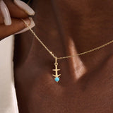 Model wears Sagittarius zodiac symbol pendant necklace in 14k solid gold with turquoise gemstone.