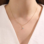 Model wears Sagittarius zodiac symbol pendant necklace in 14k solid gold with turquoise gemstone.