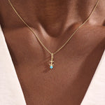 Model wears Sagittarius zodiac symbol pendant necklace in 14k solid gold with turquoise gemstone.