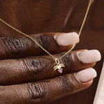 Model wears a 14k gold Aquarius zodiac pendant necklace featuring amethyst. Perfect for Aquarius zodiac birthdays and gifts.