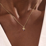 Model wears a 14k gold Aquarius zodiac pendant necklace featuring amethyst. Perfect for Aquarius zodiac birthdays and gifts.