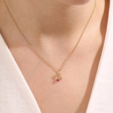 Model wears a 14k gold Cancer symbol necklace with a ruby accent. Elegant and symbolic, perfect for everyday wear or gifting.