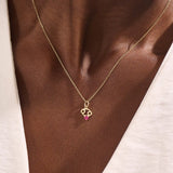 Model wears a 14k gold Cancer symbol necklace with a ruby accent. Elegant and symbolic, perfect for everyday wear or gifting.