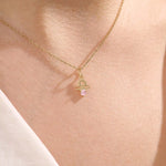 Model wears a 14k gold Libra zodiac pendant necklace featuring pink tourmaline. Perfect for Libra zodiac birthdays and gifts.