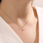 Model wears a 14k gold Libra zodiac pendant necklace featuring pink tourmaline. Perfect for Libra zodiac birthdays and gifts.