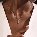 Model wears a 14k gold Libra zodiac pendant necklace featuring pink tourmaline. Perfect for Libra zodiac birthdays and gifts.
