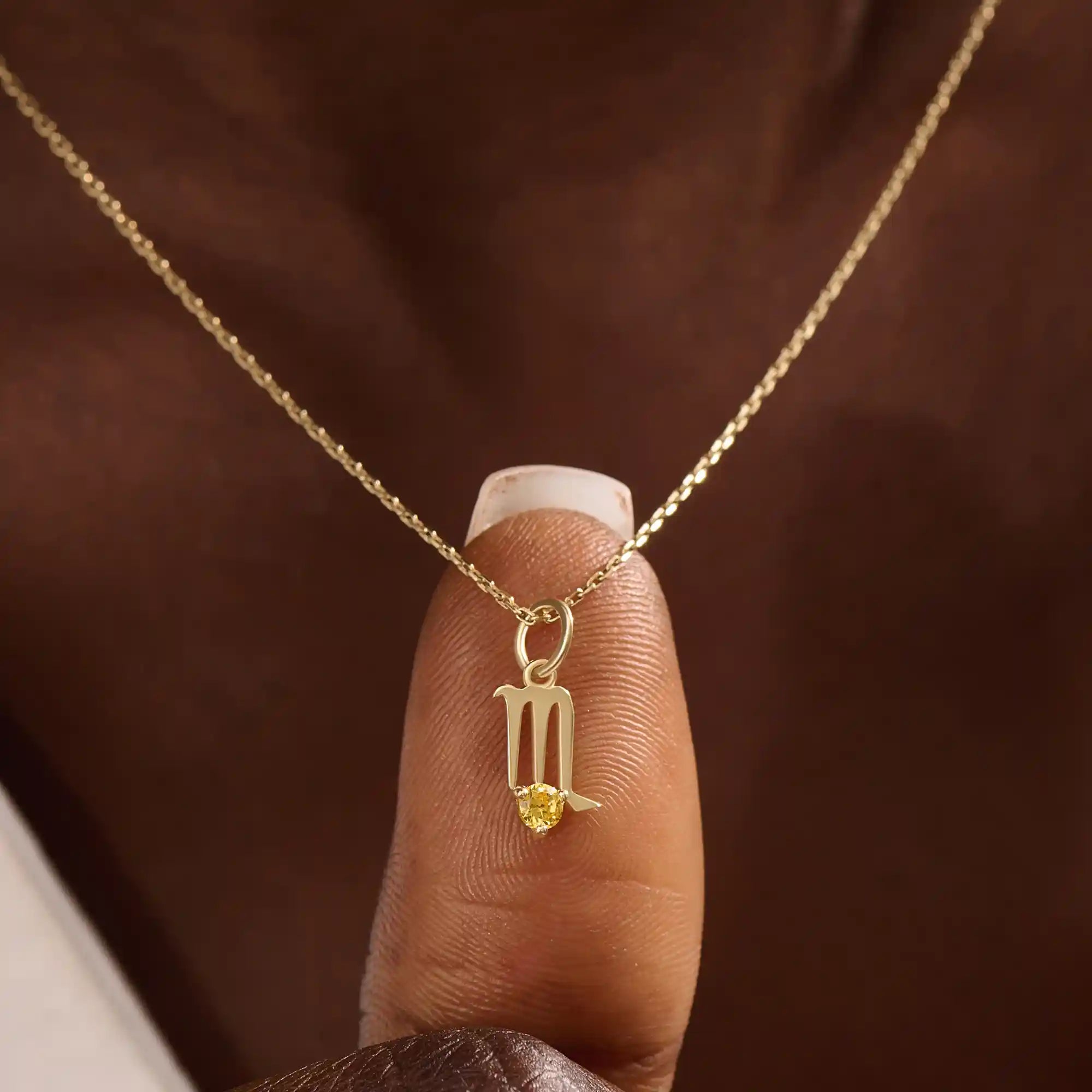 Model wears a 14k gold Scorpio zodiac pendant necklace featuring a citrine stone. Perfect gift for Scorpio zodiac birthdays.