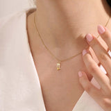 Model wears a 14k gold Scorpio zodiac pendant necklace featuring a citrine stone. Perfect gift for Scorpio zodiac birthdays.
