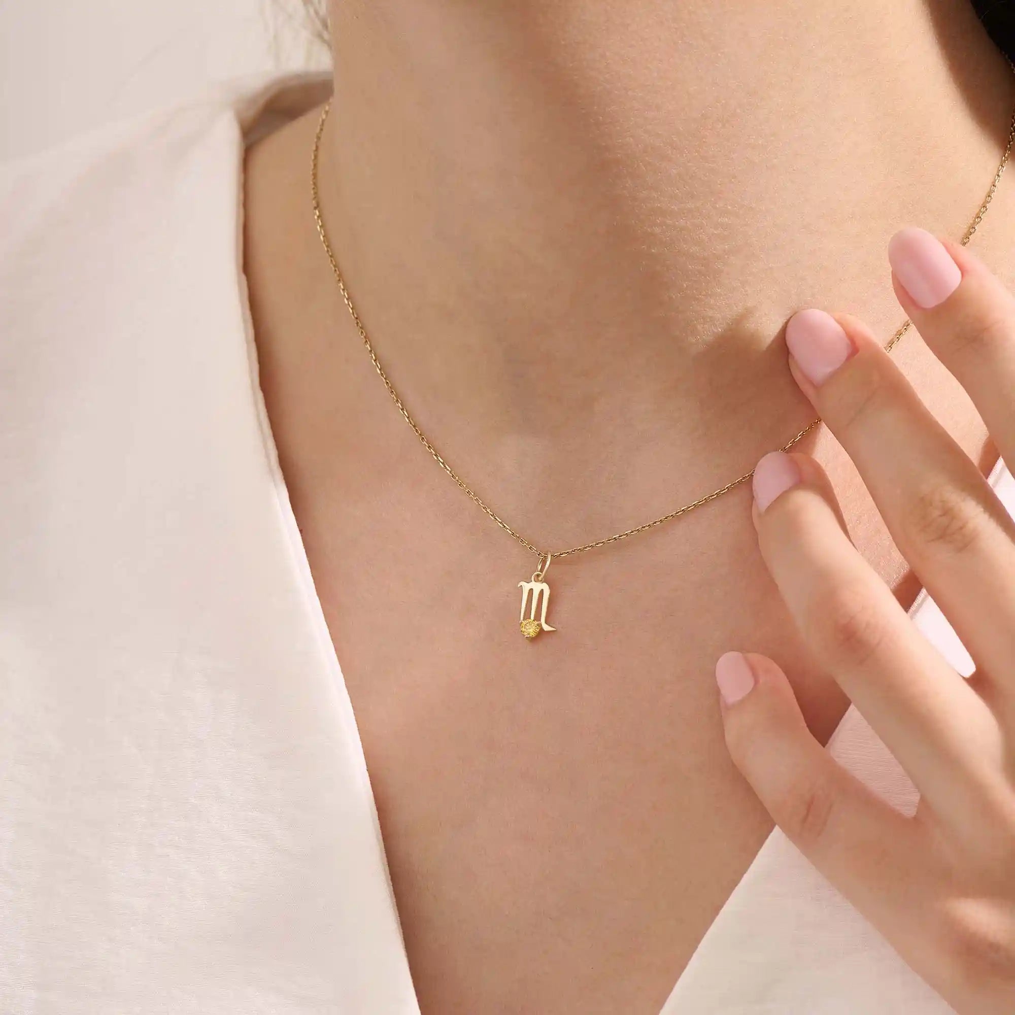 Model wears a 14k gold Scorpio zodiac pendant necklace featuring a citrine stone. Perfect gift for Scorpio zodiac birthdays.