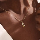 Model wears a 14k gold Scorpio zodiac pendant necklace featuring a citrine stone. Perfect gift for Scorpio zodiac birthdays.