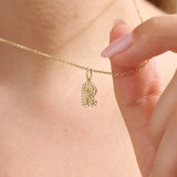 Model wears a 14k gold bubble initial necklace outlined with sparkling moissanites. Eye-catching and stylish, perfect for daily wear.