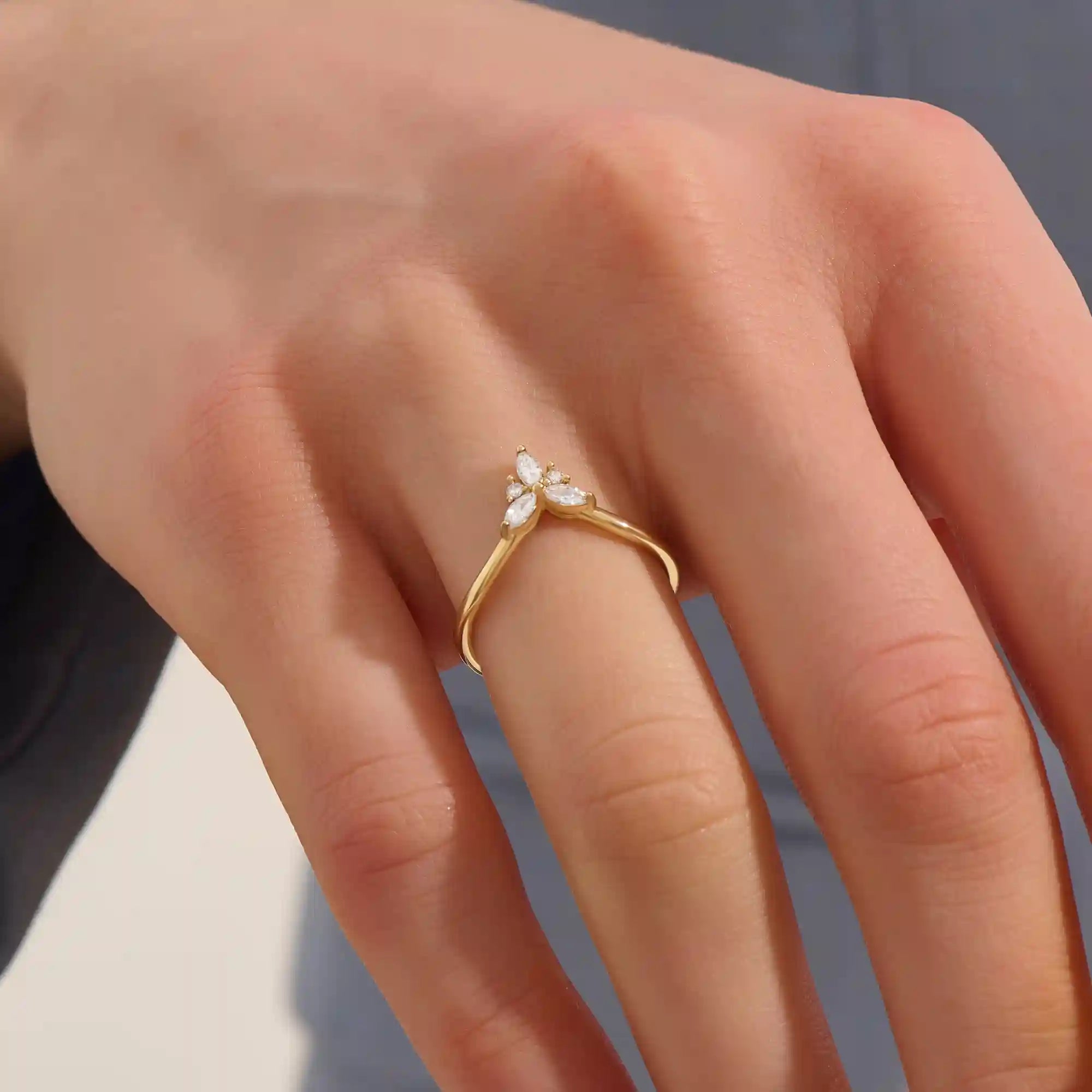 Model wears a 14k gold chevron curve nesting ring with marquise moissanites. Perfect for stacking or as a subtle statement piece.