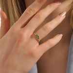 Model wears a 14k gold curve nesting ring with a marquise-cut emerald gemstone. Perfect for stacking or as a subtle statement piece.