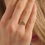 Model wears a 14k gold curve nesting ring with a marquise-cut emerald gemstone. Perfect for stacking or as a subtle statement piece.