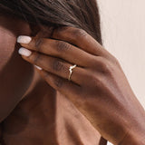 Model wears a 14k gold curved nesting ring adorned with clustered moissanites. Perfect for layering or wearing alone for subtle sparkle.