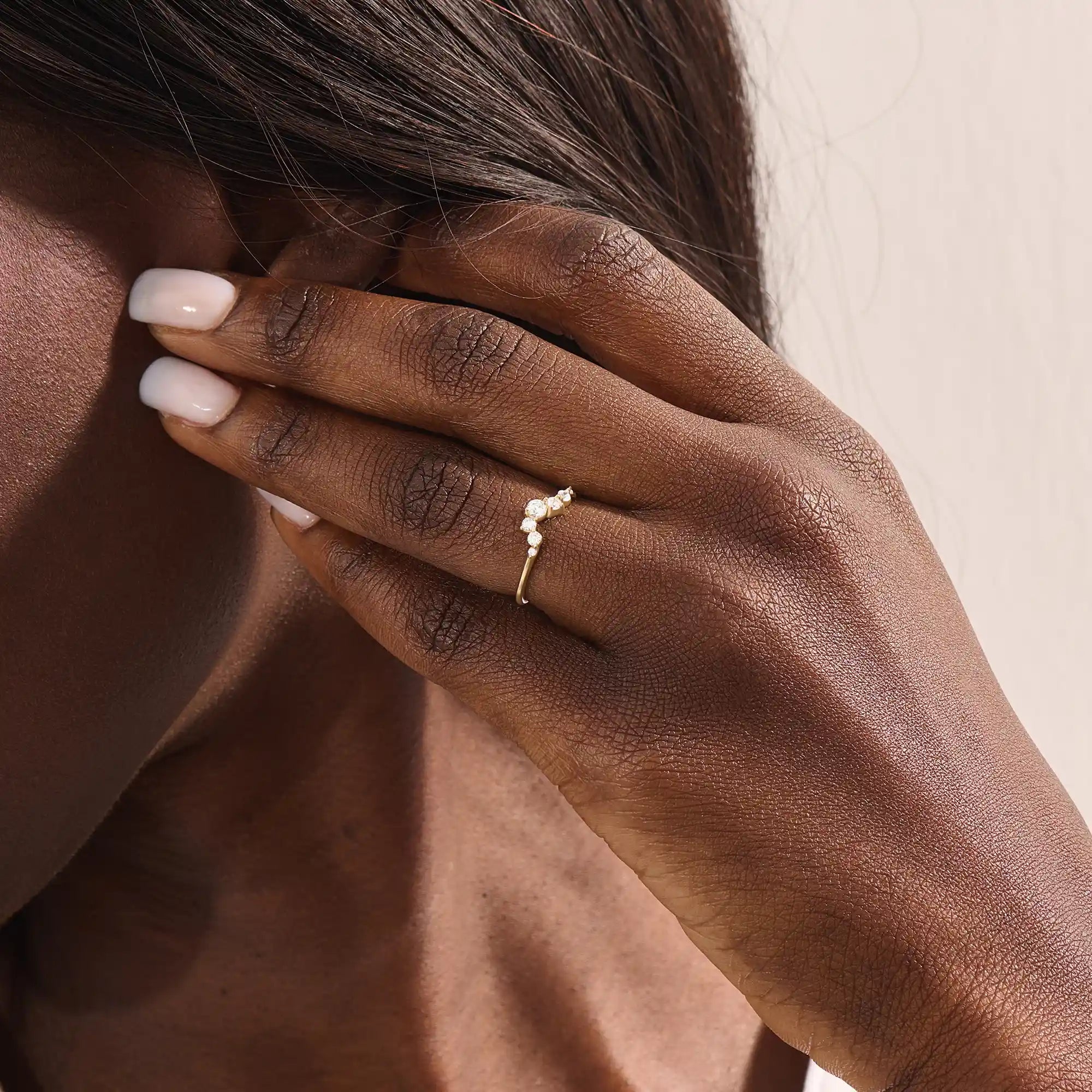 Model wears a 14k gold curved nesting ring adorned with clustered moissanites. Perfect for layering or wearing alone for subtle sparkle.