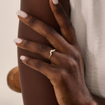 Model wears a 14k gold curved nesting ring adorned with clustered moissanites. Perfect for layering or wearing alone for subtle sparkle.
